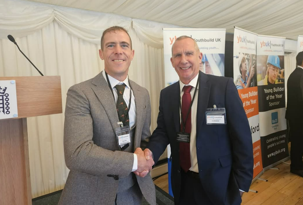 Ricky Clare shaking hands with Chris Seeley, Trustee of Youth Build UK, at the Annual Awards ceremony